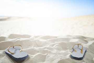 Flip flops on sand and summer time 