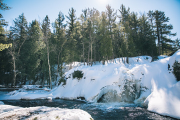 river  with waterfall in winter