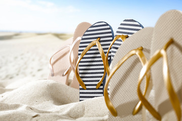 Fototapeta na wymiar Flip flops on sand and summer time 