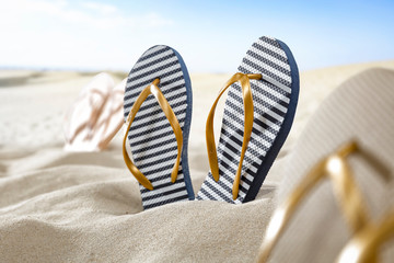 Flip flops on sand and summer time 
