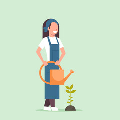 female farmer growing young seedling plant flower or vegetable woman holding watering can gardener in uniform agricultural eco farming concept flat full length
