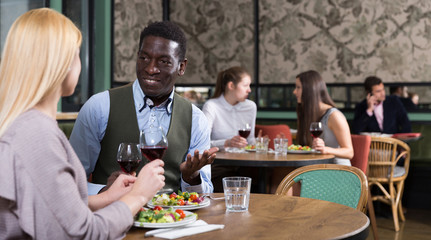 African American businessman with female partner in restaurant