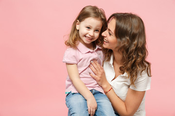 Woman in light clothes have fun with cute child baby girl. Mother, little kid daughter isolated on...
