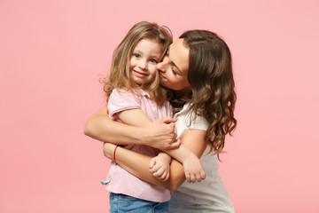 Woman in light clothes have fun with cute child baby girl. Mother, little kid daughter isolated on...
