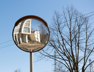 The image of the photographer and cars on the traffic curve mirror