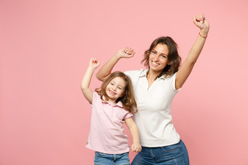 Woman in light clothes have fun with cute child baby girl. Mother, little kid daughter isolated on pastel pink wall background, studio portrait. Mother's Day, love family, parenthood childhood concept