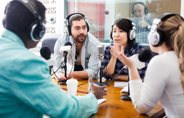 Radio hosts interviewing guest