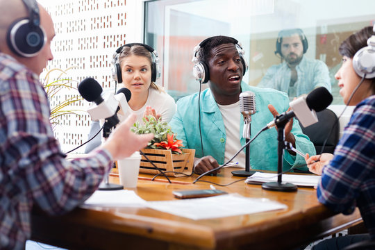 Scandal interview. Two outraged guests answering provocative questions of radio hosts during live radio show