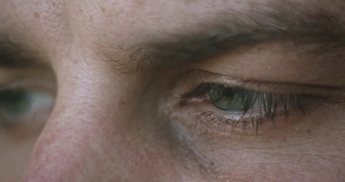 man eyes moves from side to side, reading from center to down, closeup