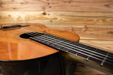 Fototapeta premium Old classical guitar on wooden background