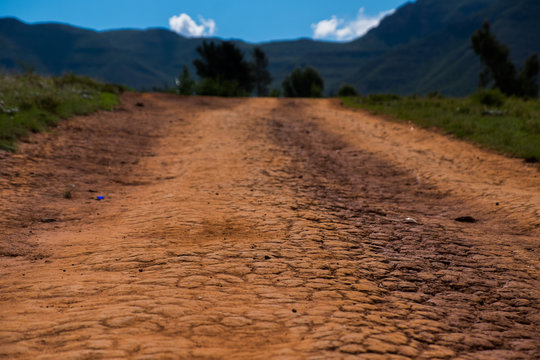 Close Up Of Dry And Cracked Orange Dirt Road, Lesotho, Africa