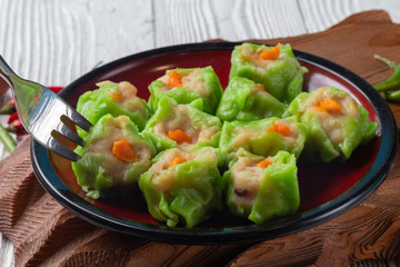 Chinese steamed pork dumpling dim sum on plate