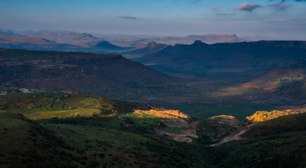 Landscape view over mountains and the sun shining through the clouds, Lesotho, Africa