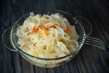 salad homemade sauerkraut in a glass jar on a table