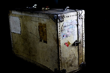 Close up of isolated old used suitcase with rivets, leather grip and combination locks