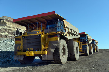 Obraz premium Large quarry dump truck. Loading the rock in the dumper. Loading coal into body work truck