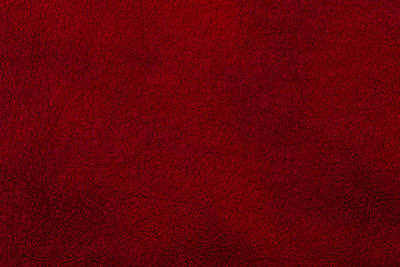 Dark red leather surface as a background, leather texture. 