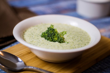 Brocolli creme plate on a blue wood table