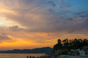 Amazing sea sunset on the pebble beach, the sun, waves, clouds