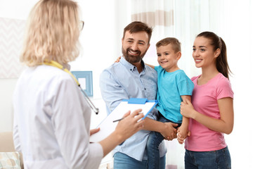 Children's doctor visiting little boy at home