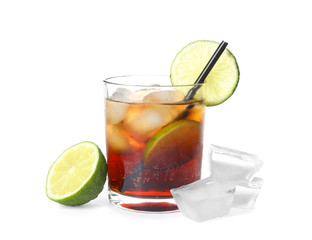 Glass of cocktail with cola, ice and cut lime on white background