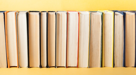 Row of old colorful books. Education background. Back to school. Copy space for text.