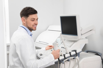 Fototapeta premium Sonographer operating modern ultrasound machine in clinic