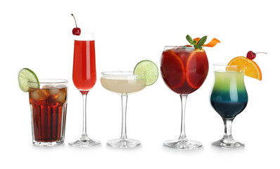 Glasses of traditional alcoholic cocktails on white background