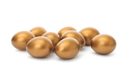 Many shiny golden eggs on white background