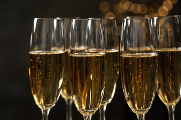 Many glasses of champagne on blurred background, closeup