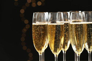Glasses of champagne on blurred background, closeup. Space for text