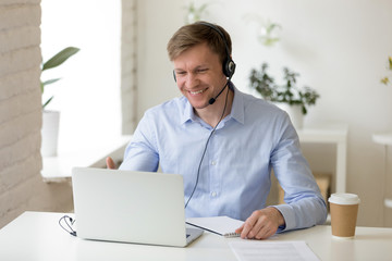 Smiling man in headphones making business video call