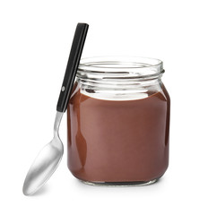 Glass jar with tasty chocolate cream and spoon isolated on white