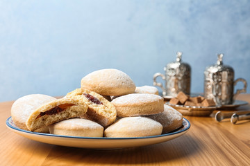 Plate of traditional cookies for Islamic holidays on table, space for text. Eid Mubarak
