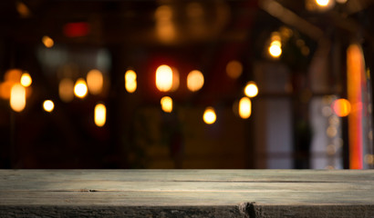 blurred background of bar and dark brown desk space of retro wood