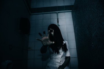 Portrait of asian woman make up ghost face with blood,Horror scene,Scary background,Halloween...