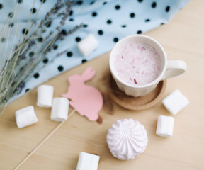 Fototapeta na wymiar Fresh strawberry smoothie with marshmallows, close-up. Easter concept. Creative spring flatlay, top view