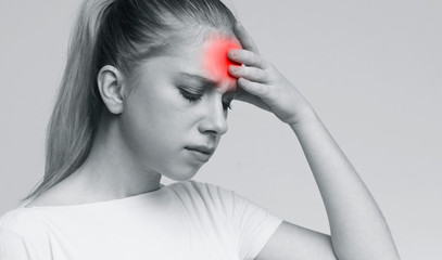 Young woman suffering from terrible strong head pain