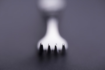 Fork concept with bokeh in black and white