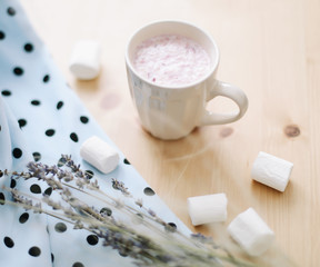 Fresh strawberry smoothie or milkshake. Tasty yogurt with marshmallows on light wooden background, close-up. Creative minimal summer flatlay, top view