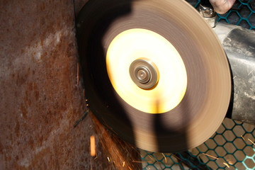 Electric grinding wheel on the steel structure, Bulgarian close-up. Sparks from the grinder