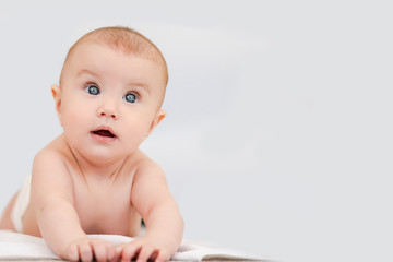 Portrait of smiling baby girl with blue eyes