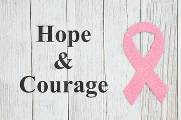 Hope and Courage message with pink ribbon on textured weathered whitewash wood