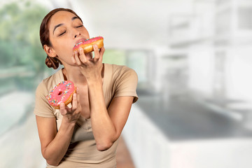 Woman eating a huge donut, Breaking diet with a mouth watering cake