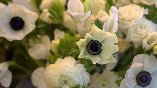 slider view of a bouquet of anemon, lisianthus, frezya