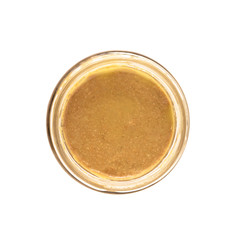 Top view of open glass jar with nut butter, hummus or sesame paste tahini isolated on white background