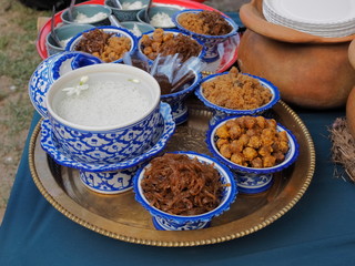 Khao Chae (rice in iced water with Jasmine flower) traditional Mon food  and many dessert in the plate.