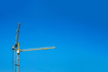 Two cranes against the blue sky.