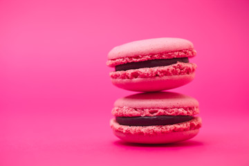 Two macarons on magenta background