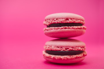 Two macarons on magenta background